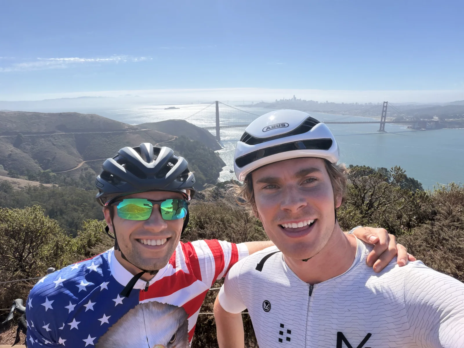 Two team members on a bike ride with the Golden Gate Bridge in the background.